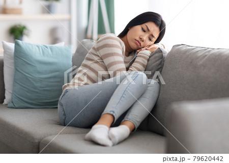 Depression Concept. Portrait Of Sad Asian Woman Sitting On Sofa At Home 79620442