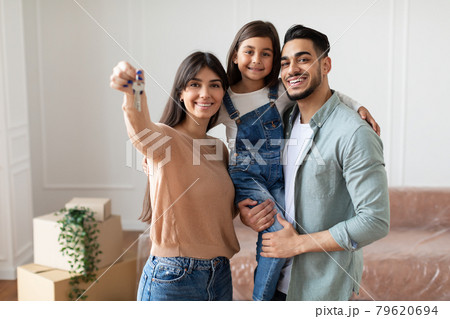 Happy young family showing keys of their apartment 79620694