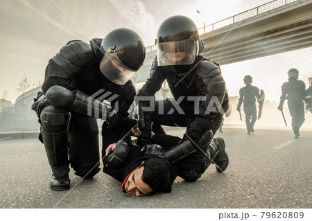 Arresting protester on street Arresting protester on street 79620809