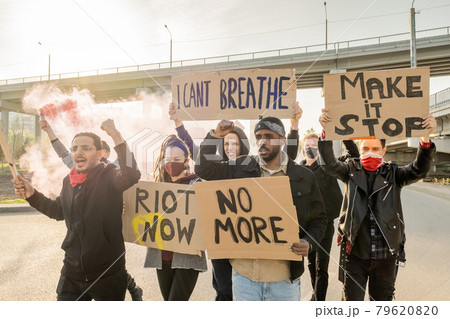 Activists moving with signs on street 79620820