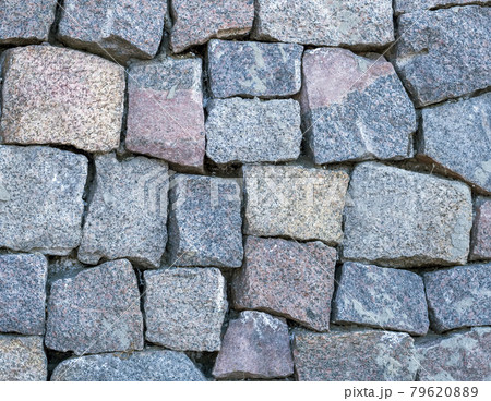 Wall masonry from chipped granite blocks. Wall stone pattern. 79620889