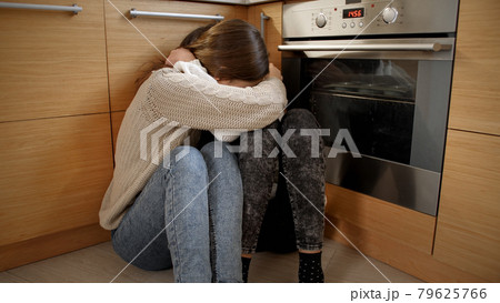 POV of angry person moving towards two afraid girls crying on floor and hugging. Concept of domestic violence and family aggression. 79625766