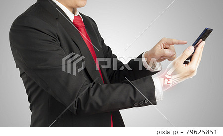 office worker holding mobile phone feels pain his wrist 79625851