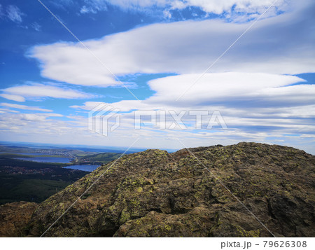 A large stone on the background of mountains with trees A large stone on the background of mountains with trees 79626308
