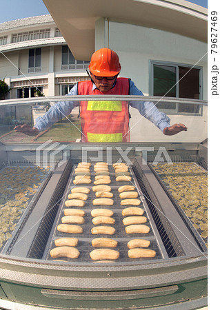 Asian male engineer checking and recording solar fruit incubator. 79627469