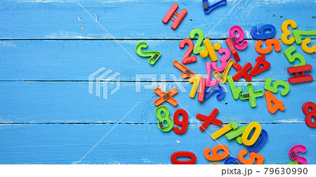 plastic numbers with magnet scattered on blue wooden background, top view plastic numbers with magnet scattered on blue wooden background, top view 79630990