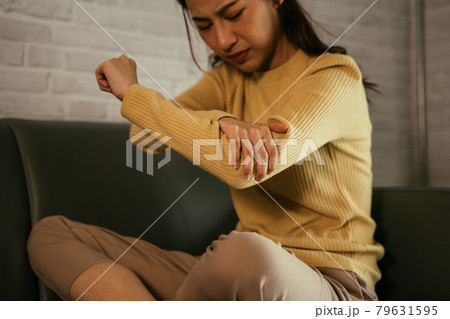 Young female suffering from elbow pain Young female suffering from elbow pain 79631595