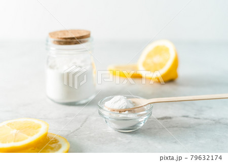 Eco friendly natural cleaners, jar with baking soda, lemon and wooden spoon on marble table background. Organic ingredients for homemade cleaning. Zero waste concept Eco friendly natural cleaners, jar with baking soda, lemon and wooden spoon on marble table background. Organic ingredients for homemade cleaning. Zero waste concept 79632174