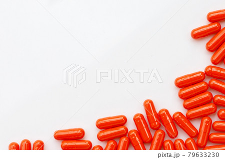 Orange capsule pills on white background. Orange capsule pills on white background. 79633230