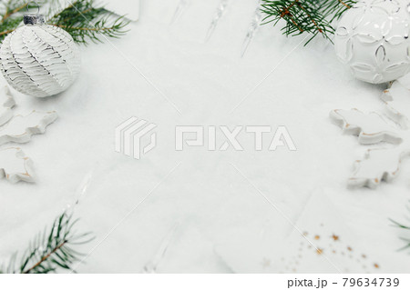 White christmas card with decor, balls, branch of fir on snow, white background White christmas card with decor, balls, branch of fir on snow, white background 79634739