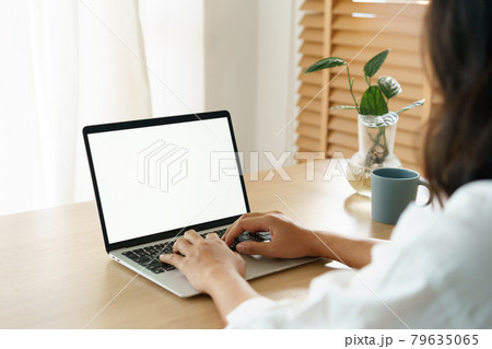 Blank digital computer laptop white screen, Asian women typing work from home via shoulder close up Blank digital computer laptop white screen, Asian women typing work from home via shoulder close up 79635065
