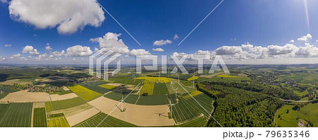 Panoramic aerial view over giant wind power field in Germany during daytime 79635346