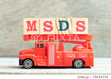 Fire ladder truck hold letter block in word MSDS (Abbreviation of material safety data sheet) on wood background 79636356