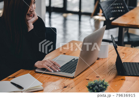 Charming asian woman working laptop at coffee cafe shop Charming asian woman working laptop at coffee cafe shop 79636915