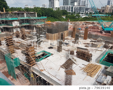 PENANG, MALAYSIA -JUNE 16, 2021: Structural works are underway at the construction site. Construction workers are installing formwork made of metal or timber. Safety features are paramount. 79639140