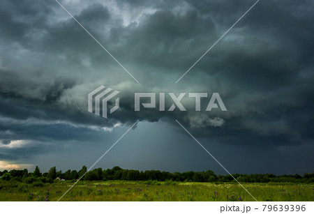 Extreme thunderstorm shelf cloud moving over fields, climate change concept 79639396