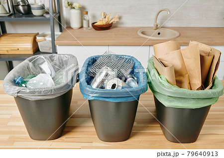 Row of three trash bins with sorted garbage Row of three trash bins with sorted garbage 79640913