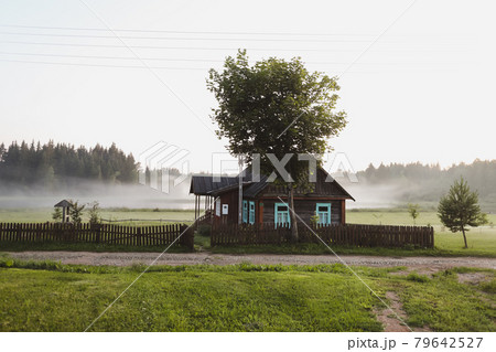 wooden european house in a picturesque countryside at sunset in summer wooden european house in a picturesque countryside at sunset in summer 79642527
