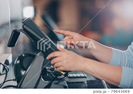POS concept, young woman hand doing process payment on a touchscreen cash register, finance, shopping POS concept, young woman hand doing process payment on a touchscreen cash register, finance, shopping 79643069