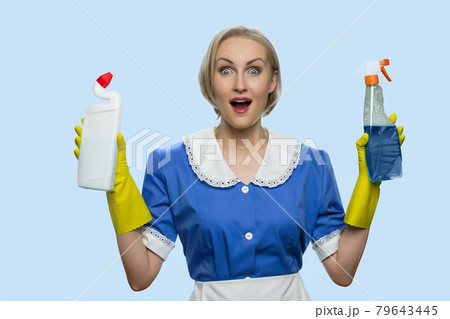 Happy shocked housekeeping woman presenting cleaning supplies. Happy shocked housekeeping woman presenting cleaning supplies. 79643445