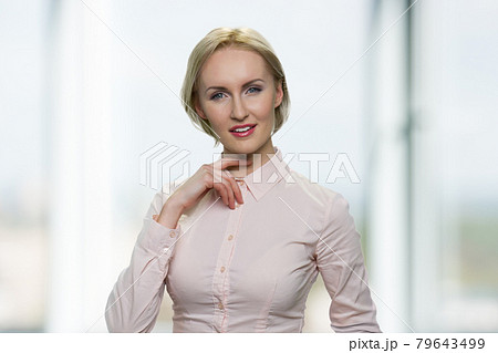 Portrait of beautiful young woman looking at camera. Portrait of beautiful young woman looking at camera. 79643499