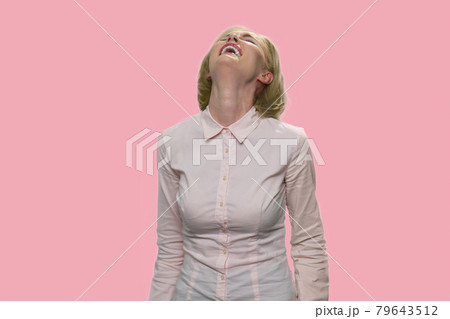 Young woman is laughing hard at something hilarious. 79643512