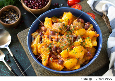 Thanksgiving Autumn Menu. Stew with beans and vegetables in a bowl on a rustic table. 79643955