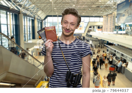 Portrait of cute tourist boy showing passports. Portrait of cute tourist boy showing passports. 79644037