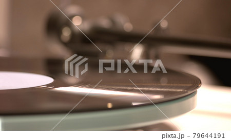 Vintage record is playing by the gramophone. 79644191