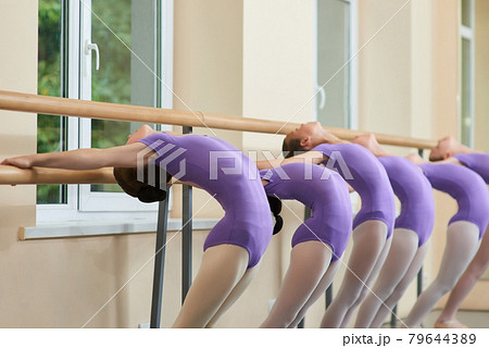 Young ballerinas stretching at ballet barre. 79644389