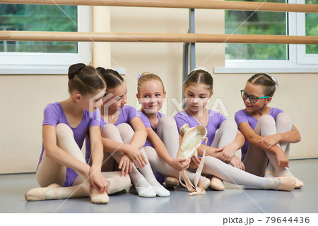 Young ballerina with new ballet slippers. 79644436