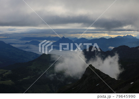 Sunrise scene seen from Mount Brienzer Rothorn. View towards Stanserhorn and Lucerne. Fog lifting slowly after a rainy night. Sunrise scene seen from Mount Brienzer Rothorn. View towards Stanserhorn and Lucerne. Fog lifting slowly after a rainy night. 79645990