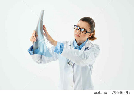 woman doctor in white coat looking at x-ray diagnostics close-up woman doctor in white coat looking at x-ray diagnostics close-up 79646297