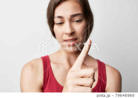 woman red tank top injured index finger bandage treatment woman red tank top injured index finger bandage treatment 79646960