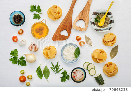 Italian foods concept and menu design. Various kind of Pasta with wooden spatula set up on white wooden background with flat lay. Italian foods concept and menu design. Various kind of Pasta with wooden spatula set up on white wooden background with flat lay. 79648238