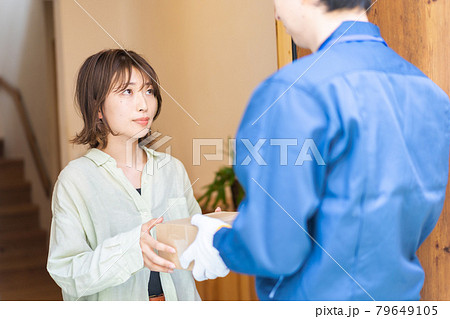 デリバリーを受け取る若い女性 デリバリーを受け取る若い女性 79649105
