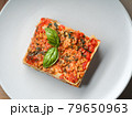 Piece of lasagna on white plate close-up. Menu of 79650963