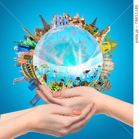 Woman holding globe on her hands, 79651180
