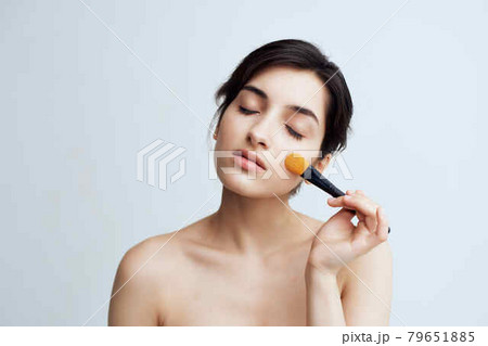 woman with bare shoulders makeup brush cosmetics skin care close-up woman with bare shoulders makeup brush cosmetics skin care close-up 79651885