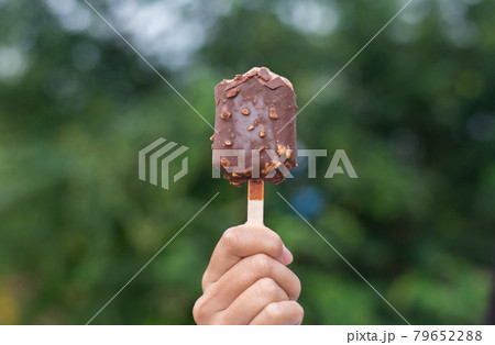 Hands woman holding chocolate ice cream waffle cone calories at nature,Close up Hands woman holding chocolate ice cream waffle cone calories at nature,Close up 79652288