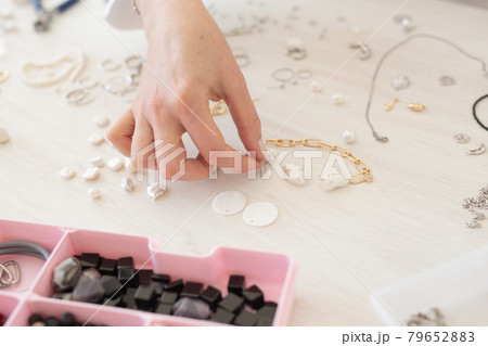 Professional jewelry designer making handmade jewelry in studio workshop close-up. Fashion, creativity and handmade concept 79652883