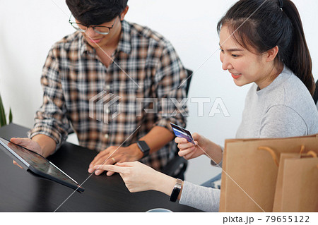 Shopping online concept a lovely couple adding credit card information to use in online financial transaction 79655122