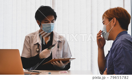 Doctor giving advice to a man patient. 79655782