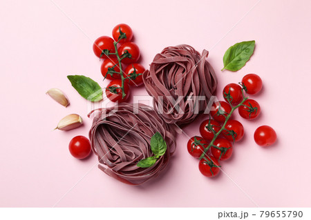Uncooked pink pasta and ingredients on pink background 79655790