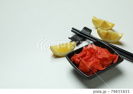 Pickled ginger, chopsticks and lemon on white background 79655835