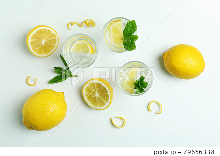 Shots of vodka and lemons on white background 79656338