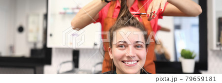 Portrait of smiling woman in hairdressing salon, which master cuts her hair Portrait of smiling woman in hairdressing salon, which master cuts her hair 79659181