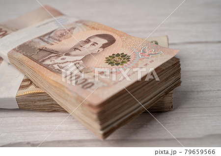 Stack of Thai baht banknotes on wooden background, business saving finance investment concept. Stack of Thai baht banknotes on wooden background, business saving finance investment concept. 79659566
