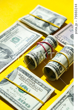 US dollars bundle close up isolated on dollar background. Paper denominations of dollars cash rolls with rubber bands. Business budget of wealth and prosperity finance. US dollars bundle close up isolated on dollar background. Paper denominations of dollars cash rolls with rubber bands. Business budget of wealth and prosperity finance. 79660244