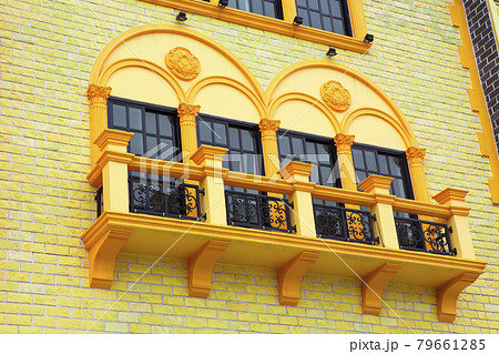 The windows of the building are colorful. 79661285